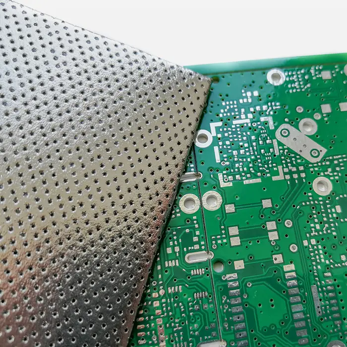 a close up of a green circuit board with holes in it