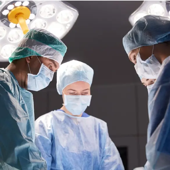 a group of surgeons are performing surgery in an operating room